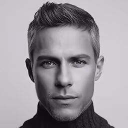 Headshot of a man with short hair and light skin in grayscale.