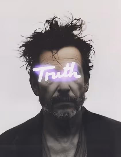 Black and white portrait of a man with messy hair and a beard, with the word 'Truth' illuminated across his eyes.
